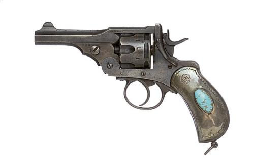 A British Webley revolver decorated with Navajo silver and turquoise.  Complete with leather rig. La