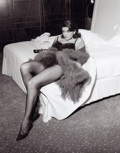 celebritiesinpantyhose: A young Catherine Zeta Jones seductively poses on a bed while wearing sheer 