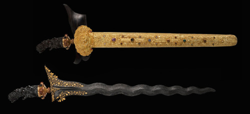 Indonesian or Malaysian kris with gold decorated blade and gem studded carbed ebony hilt, 20th centu