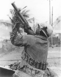 victran:  vietnamwarera:  A Marine fires his M79 at a sniper’s position during the Battle of Hue, 1968.  holy shit carried a shit ton of 40 mike mike  