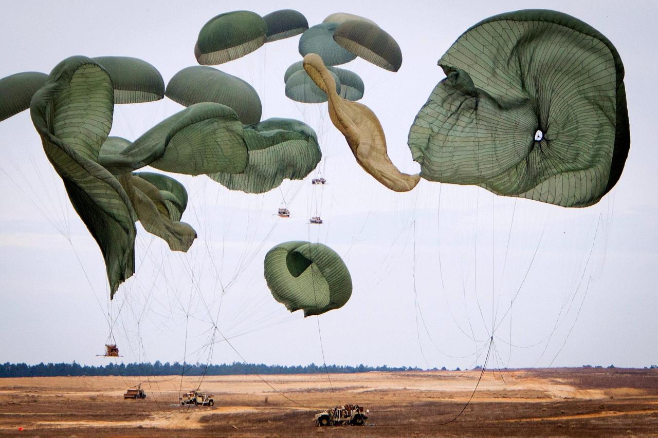 Giant parachutes collapse as their load of Humvees hit the ground during a joint operational access exercise on the Sicily drop zone at Fort Bragg, North Carolina, USA.
Paratroopers will descend once the heavy equipment is safely on the...