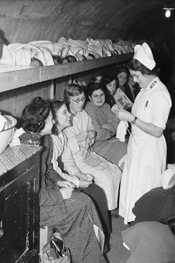 indypendenthistory:  Sheltering from the Blitz, October 5, 1940 Women, girls and babies (lying on the shelf) wait in an air raid shelter run by the Salvation Army in Clapton, east London, during the Blitz. (via Long-gone East End London - Telegraph) 
