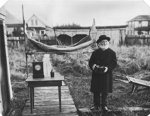 “William Duncan late in life, exhibiting to friends for photographing the canvas, hammock, clock, wa