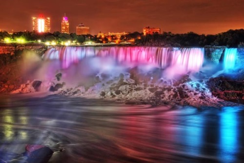 sixpenceee:Niagara Falls Illumination Every evening beginning at dusk, the Falls are lit in the colo