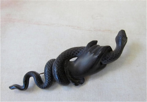 Black Victorian Mourning Jewellery.Hand and snake gutta percha mourning brooch.