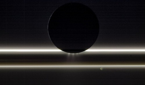 just–space:Enceladus in Silhouette : One of our Solar System’s most tantalizing worlds, Encela