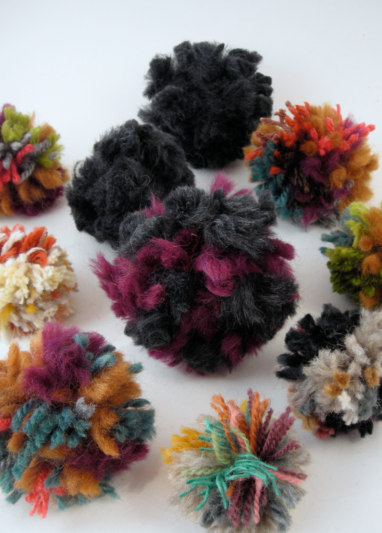 I’ve been making pom poms with my weaving scraps. I usually only have enough (from one weaving) for one pom pom, but I made six from all of these yarn tails!