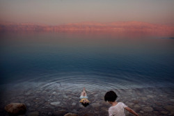 unrar:    Floating on dreams and whispers, girls from a West Bank village cool off in the waters of the Dead Sea, Palestine,   Paolo Pellegrin. 