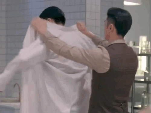 chusheng helping lu yao put on his autopsy blouse