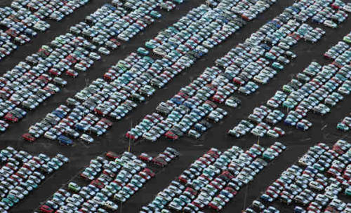 mansfrombelow:canadian-communist:Where the World’s Unsold Cars Go to Die Above are photos 