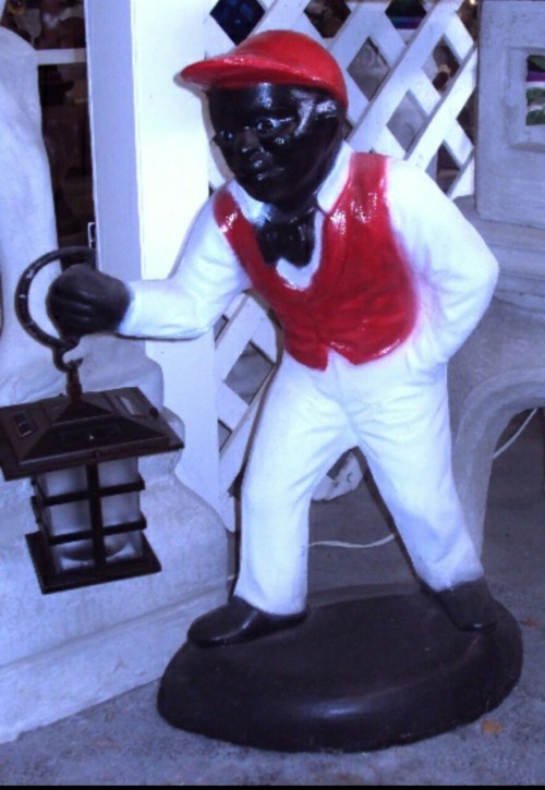 wakeupslaves:  The African-American lawn jockeys often had exaggerated features, such as big eyes with the whites painted in, large red lips, large, flat nose and curly hair. These pieces were typically painted in gaudy colors for the uniform, with the