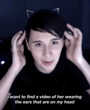 cringe-attacks:dan on ariana grande giving him and phil cat ears {x}