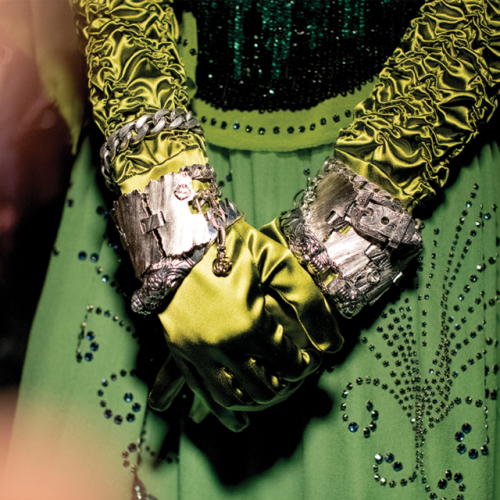 Jeweled finger rings, decorated cross pendant necklaces, and gold metal ear coverings and ear shaped