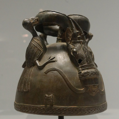 Yoruba-style helmet (copper alloy) depicting two birds of prey attacking a horse-headed snake.  From
