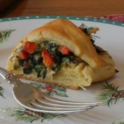 A ring of crescent roll dough is stuffed with a delicious combination of chicken, red bell pepper, s