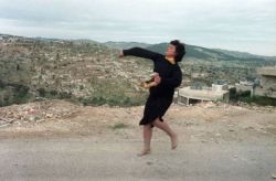 tanyushenka:  Palestinian Christian woman, took off her high heel shoes as she throws stones at Israeli soldiers, 1988 in Beit Sahur in the West Bank. Photographer: Esaias Baitel 