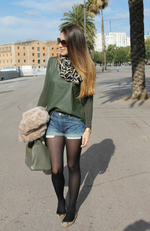 Fashion woman in black pantyhose, flat shoes and short denim short.Woman in pantyhose