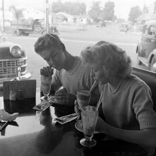 fuckyeahvintage-retro:  A young couple eating at a drive-in. California, 1946 © Martha Holmes