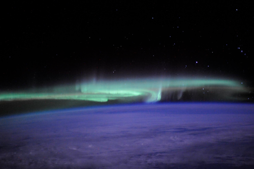 nubbsgalore: the earth adorned in a phosphorescent crown of light, as supercharged plasma spewed fro