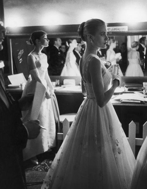 thefashioncomplex:Audrey Hepburn and Grace Kelly wait backstage at the RKO Pantages Theatre during t