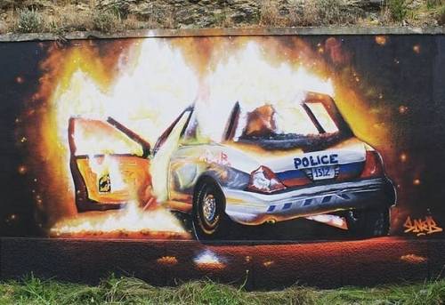 Burning cop car mural seen in Lisbon, Portugal