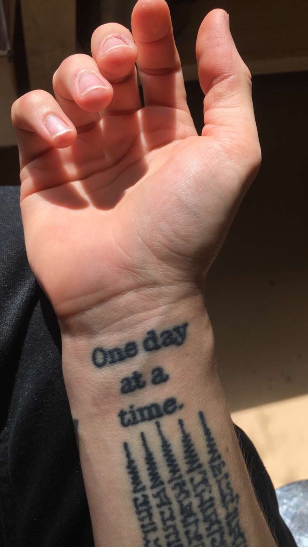 One day at a time lettering tattoo on the inner
