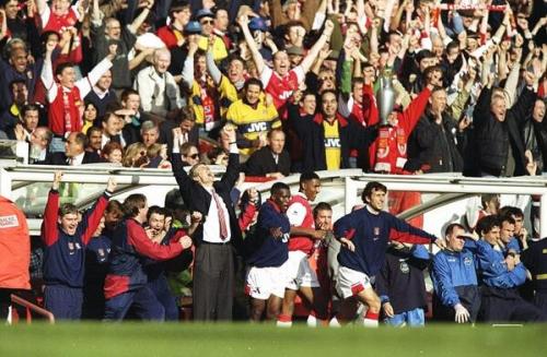 Wenger and company celebrate a 4-0 win for Arsenal over Everton that clinched the league title in 19