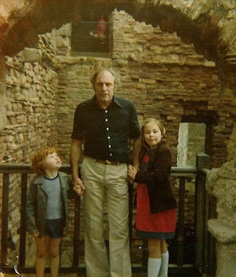 This ghostly photograph taken by Grace Lamb, shows her husband Hugh, and their two children.Experts are examining what appears to be a figure in the window at the top of the picture. She seemed to be wearing period costume, including a frilled ruff. A