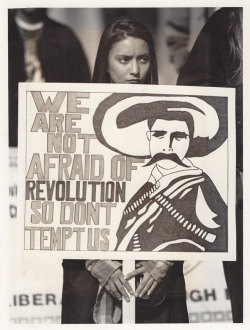 floricanto-canela:  from a chicanx protest i attended in boulder, colorado. a local newspaper photographer took this photo of a beautiful young girl — she was at the forefront of the crowd. there is something so fierce and unwavering about both her