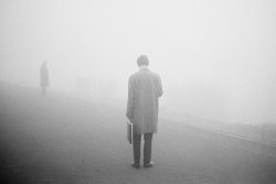 themaninthegreenshirt:  Lone man pausing in the fog,1975 by Martin Parr - great photo!