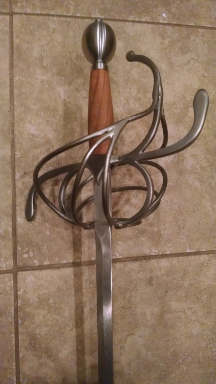 wearefighter: A few pictures of my rapier, spurred by chatting about fencing with @wearebard. Darkwood Armories, three-ring swept hilt rapier with cherry handle and a 39″ practice blade (with a blunt, hence the wonky-looking tip). 46″ total length,