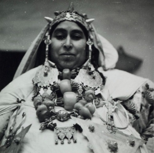 Woman from Bouizakarne wearing her traditional headgear and necklaces, Morocco, 1937.