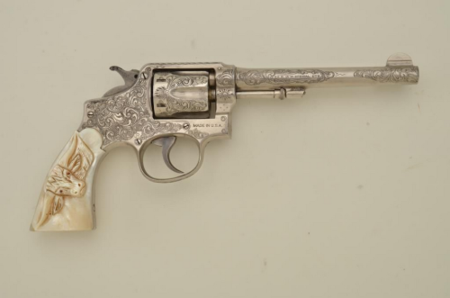 An engraved Smith and Wesson Police Model .38 revolver with carved pearl grips, early 20th century.