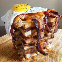 lifejoyaddict:Breakfast Jenga - (thick cut fries, melted cheese, bacon, and fried egg) - [600x600]  Oh god, I&rsquo;m getting a heart attack just looking at it!&hellip;I want to sample this&hellip; maybe just a nibble?