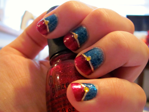 shinykari:  Captain Marvel manicure! Waaaay more complicated than most of my other manicures, but Carol is totally worth it. China Glaze ‘Ruby Pumps’ and ‘Dorothy Who?’ with gold striping tape and rhinestones, with two coats of Seche Vite to seal.