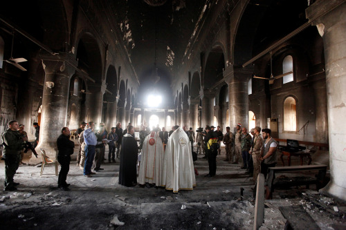 Assyrian Iraqi priests hold the first mass in the heavily damaged Church of the Immaculate Conceptio