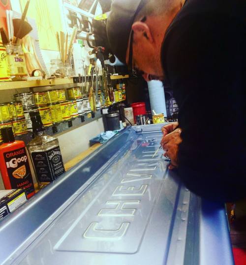 Putting the finishing touches on a friends 55 1st series tailgate. #107 #107pinstriping #107graphics