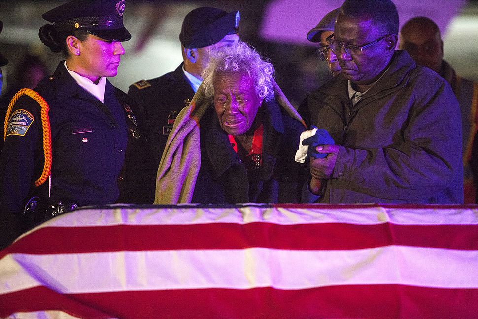 Clara Gantt, the 94-year-old widow of Army Sergeant 1st Class Joseph Gantt weeps as his casket arrived at Los Angeles International Airport early Friday morning. After a tour of duty during World War II, Gantt was captured in the Korean War and was...