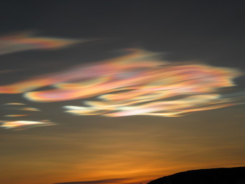 Seth White, UNAVCO - Iridescent polar stratospheric clouds glitter in the low light of the spring su