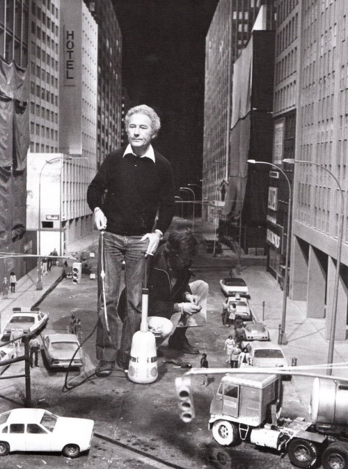 Miniature special effects master Derek Meddings works on the set of Superman 2, preparing the miniature Metropolis city street for the scene of the battle with the Kryptonians.