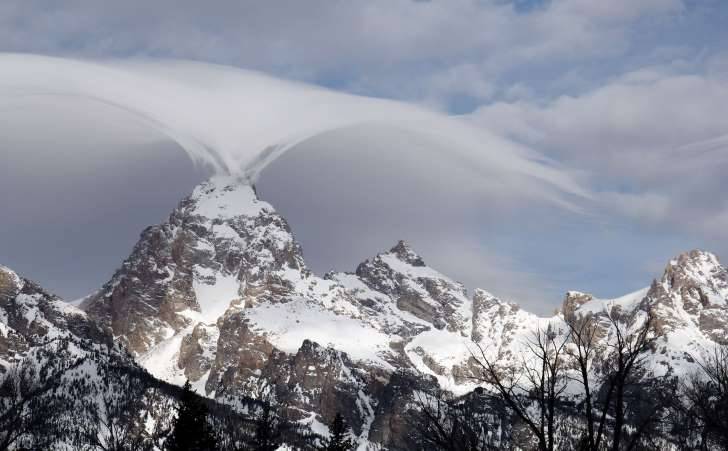 sixpenceee: A bizarre sheet of wispy clouds undulating over the Teton Range enchanted