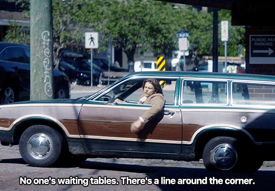 GIF FROM EPISODE 3X01 OF NANCY DREW. ACE IS SITTING IN HIS CAR WITH ONE ARM HANGING OUT OF THE WINDOW. HE SAYS "NO ONE'S WAITING TABLES. THERE'S A LINE AROUND THE CORNER." THE SHOT CUTS TO ADDY SITTING ACROSS THE TABLE FROM BESS OUTSIDE OF A CAFE. SHE'S TWISTED AROUND IN HER CHAIR. SHE TWISTS BACK TO FACE BESS WITH A KNOWING LOOK ON HER FACE.