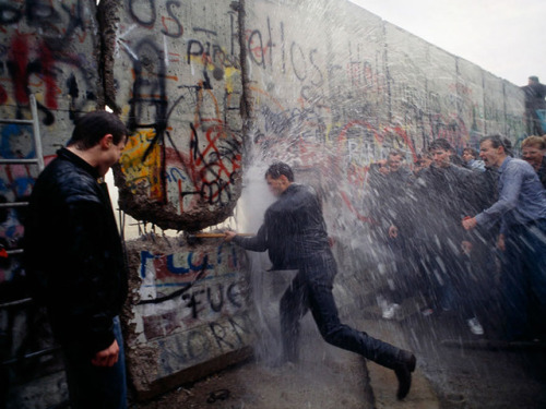 yakubgodgave:  East German border guards with water cannon attempts to stop a man hammering the Berlin Wall, November 1989  