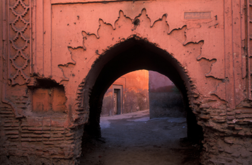 morobook:Morocco.Marrakech.A woman passing archway