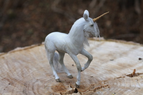 “Demure” is a one of a king unicorn sculpture, made from polymer clay over wire and foil. She is com