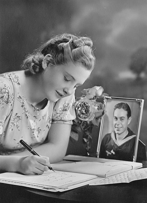 Girl writing her friend (German sailor), c1940. Photographer unknown. Private collection of Jan Weij