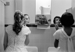 munyakare: A black girl and a white girl make up in the ladies room before an integration dinner party during the civil rights strike in America. Virginia, USA (1958) by Eve Arnold.