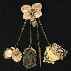 curiophile:Elaborate Victorian silver-plate on brass lilypad chatelaine.Includes a lilypad covered mirror, a small coin purse, a small retractable pencil, and a celluloid writing pad. 