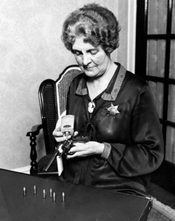 Police Department woman cleaning her gun,