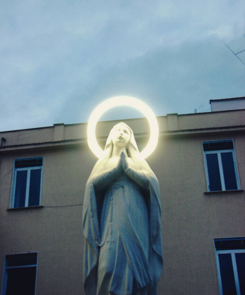 allaboutmary:A Madonna with neon halo in Naples, Italy.